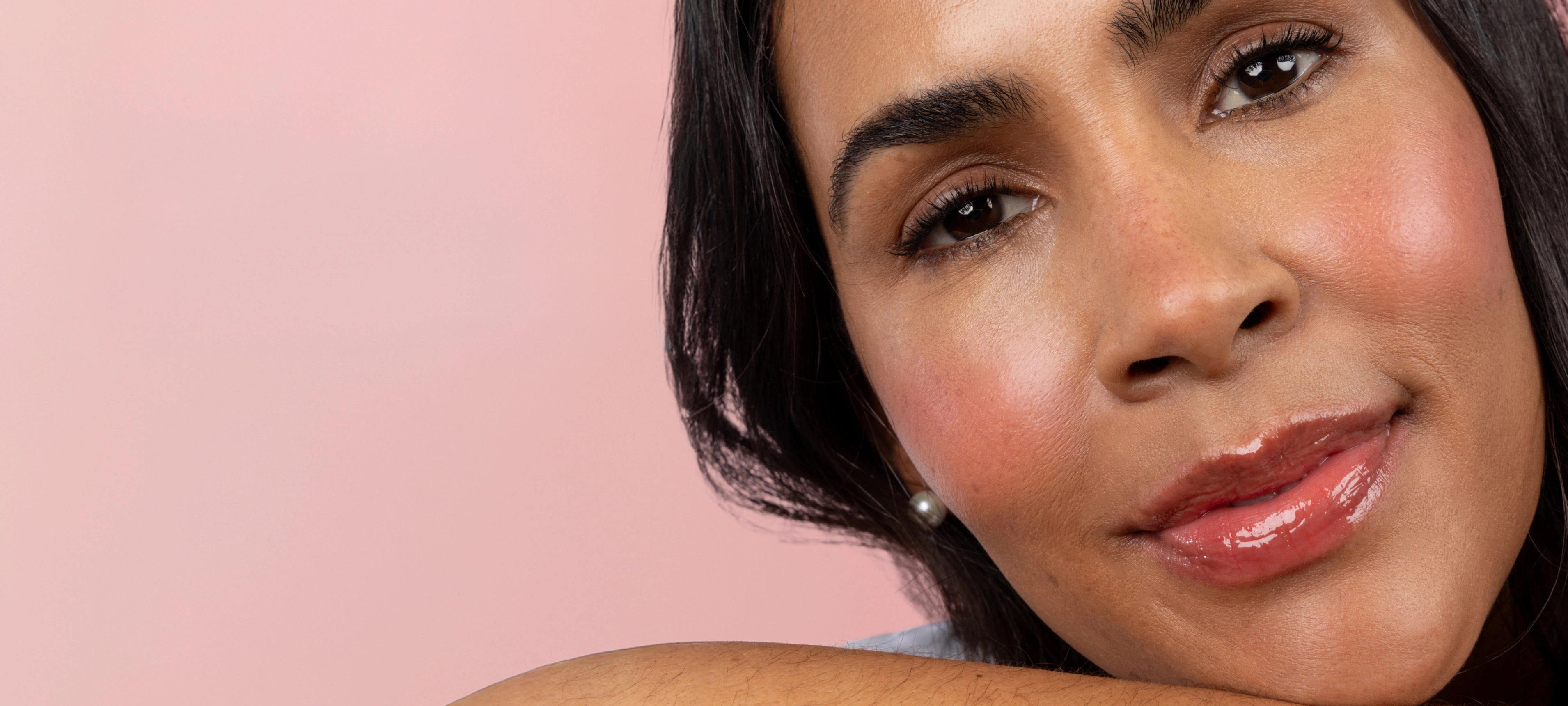 Cherry Blossom Flush - 25% Off Lip and Cheek - woman leaning on arm against pink background