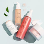 Flat-lay of PUR skincare, including Get A Lift Firming Facial Cream, Joystick cleanser, Ceretin Boost serum, and Lit Mist.